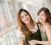 Two Smiling Asian Young Women