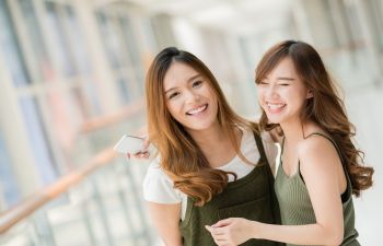 Two Smiling Asian Young Women