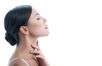 Woman Feeling Her Neck After Kybella Injections Beverly Hills CA