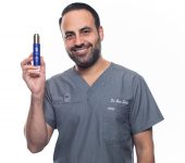 Dr. Ben Talei with Bottle of AuraSilk Face Oil