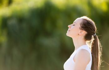 Young woman in a park relaxing in the sun