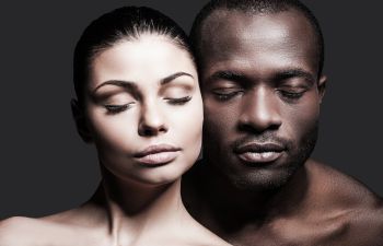 Beautiful faces of a Caucasian woman and Afro-American man with perfect skin after Facial Procedures in Beverly Hills CA