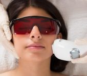 A young woman undergoing laser facial hair removal treatment in Beverly Hills, CA.