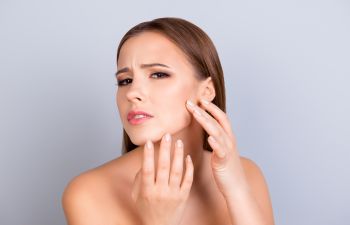 A young woman bothered by large pores before professional Skin Care Treatments in Beverly Hills, CA. Hills CA