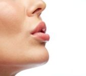 Ideally shaped full lips of a woman after Lip Procedures in Beverly Hills, CA.