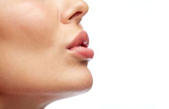 Ideally shaped full lips of a woman after Lip Procedures in Beverly Hills, CA.